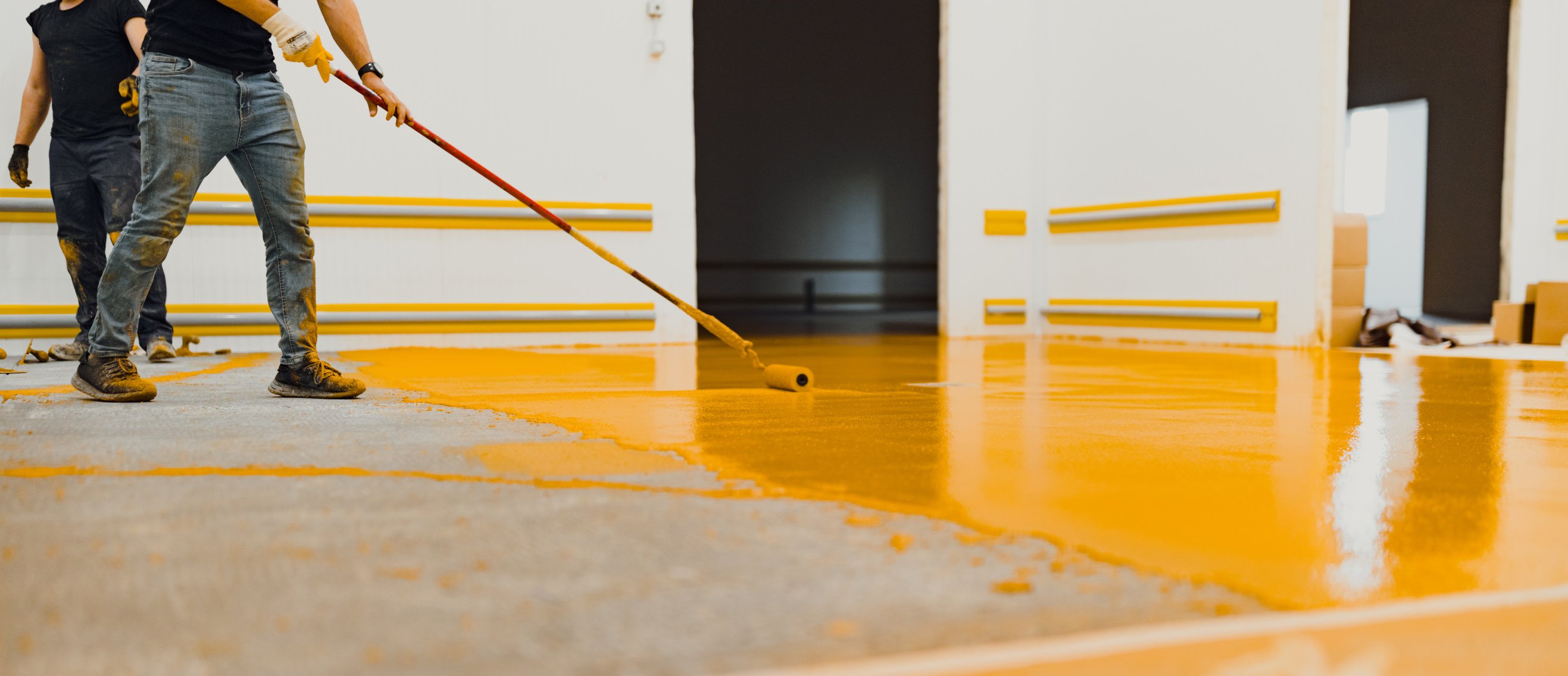 epoxy flooring applicator performs painting works with polyurethane epoxy mortar